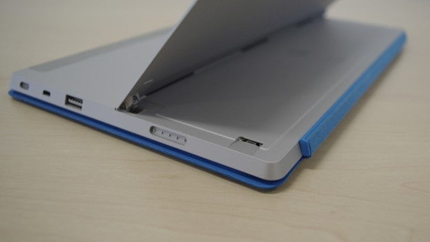 Side view of a grey and blue laptop with ports visible