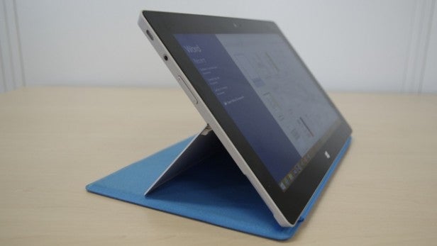 Tablet on blue stand with performance chart on screen.