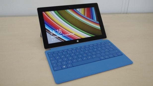 Tablet with keyboard on desk displaying colorful screen