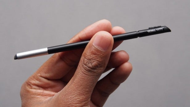 Hand holding a black and silver stylus pen.