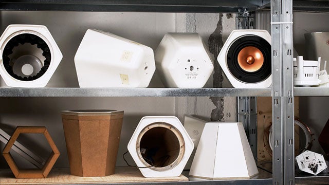 Unmonday 4.3L hexagonal speaker among prototypes on a shelf.