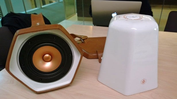 Unmonday 4.3L speaker with exposed driver next to carrying case.Unmonday 4.3L Hexagonal Speaker with Open Cover