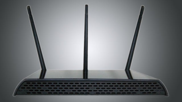 Amped Wireless RTA15 router with three antennas against a gray background.
