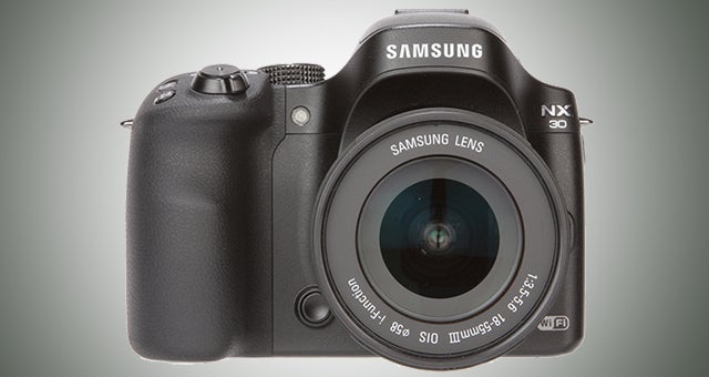 Samsung NX30 camera with lens on a gray background