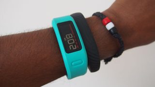 Person wearing a blue Garmin Vivofit fitness tracker.