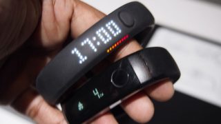 Close-up of an LG LifeBand Touch fitness tracker on a hand.