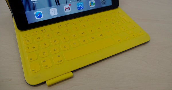Logitech FabricSkin Keyboard Folio in yellow on a desk.