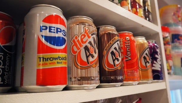 Olympus OM-D EM10Vintage soda cans displayed on a shelf.