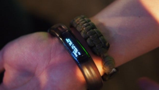 Razer Nabu wearable on wrist displaying a notification.Razer Nabu smartband on wrist displaying time and date.