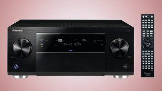 Pioneer SC-LX87 receiver and remote on pink background.