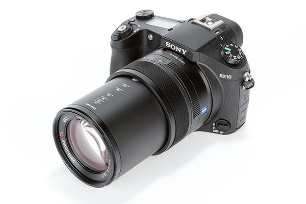 Sony RX10 camera with extended zoom lens on white background.