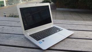 Toshiba Chromebook open on a wooden table.