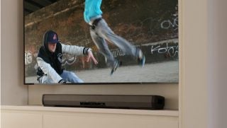 Pioneer SBX-N500 sound bar under mounted TV with action scene.