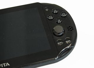 Close-up of black PS Vita Slim with buttons and joystick visible.