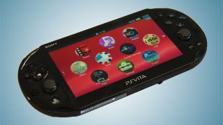 Black PS Vita Slim handheld gaming console with screen on.