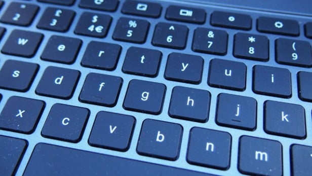 Close-up of laptop keyboard with backlit keys.