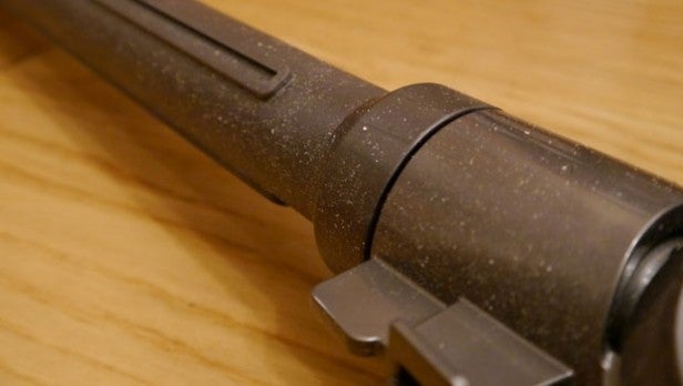 Close-up of a used vacuum cleaner nozzle on a wooden surface.