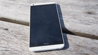 HTC Desire 816 smartphone on wooden surface.