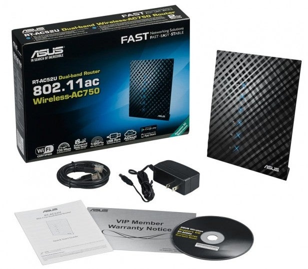 Asus RT-AC52U router with packaging and accessories.