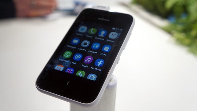 Nokia Asha 230 smartphone displaying colorful app icons.