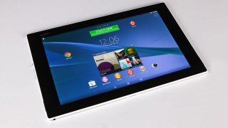 Sony Xperia Z2 Tablet on white surface displaying home screen.