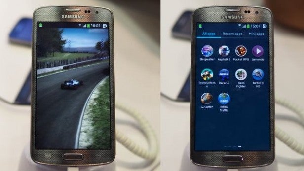 Samsung smartphone with Tizen OS showcasing screen with apps and a racing game.Samsung smartphone displaying a game and app menu.