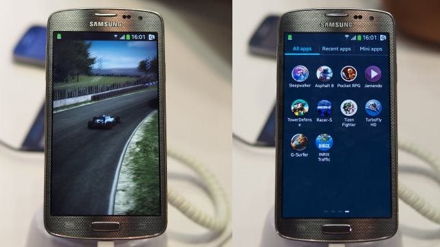 Samsung smartphone with Tizen OS showcasing screen with apps and a racing game.