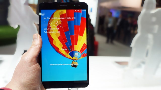 Huawei MediaPad X1 held in hand displaying home screen.