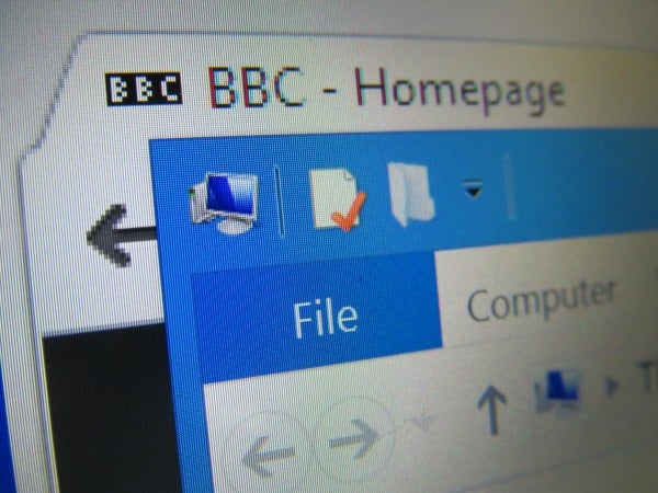 Close-up of computer screen displaying icons and BBC homepage