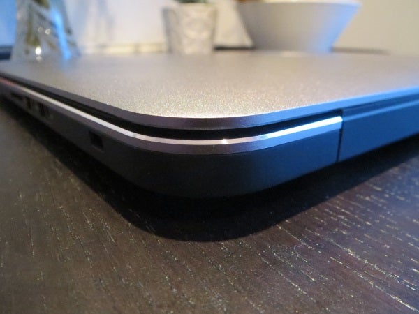 Close-up of a Dell Precision M3800 laptop corner on a table.