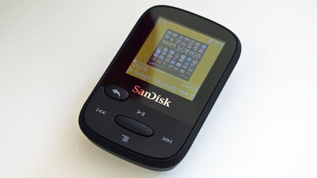 SanDisk Clip Sport MP3 player on white surface.