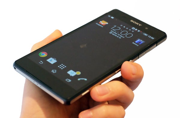 Hand holding a Sony Xperia Z2 smartphone displaying home screen.Close-up of Sony Xperia Z2's side port cover open.Close-up of Sony Xperia Z2's front camera and logo