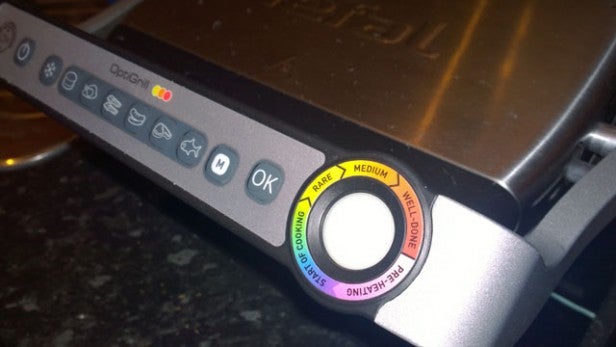 Close-up of Tefal OptiGrill's control panel with cooking settings.