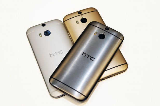 Three HTC One M8 smartphones in silver, gold, and grey.HTC One M8 color options: Metal Grey, Amber Gold, Arctic Silver.Close-up of HTC One M8 front camera and speaker grill.
