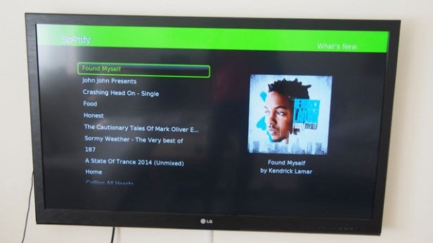 TV displaying Spotify interface with music album selections.