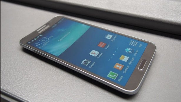 Samsung Galaxy Round smartphone on a textured surface.Samsung Galaxy Round smartphone on a table.