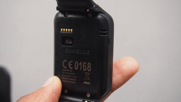 Hand holding a Samsung device showing battery compartment.