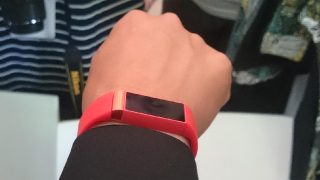 Red Acer Liquid Leap wearable fitness tracker on wrist.