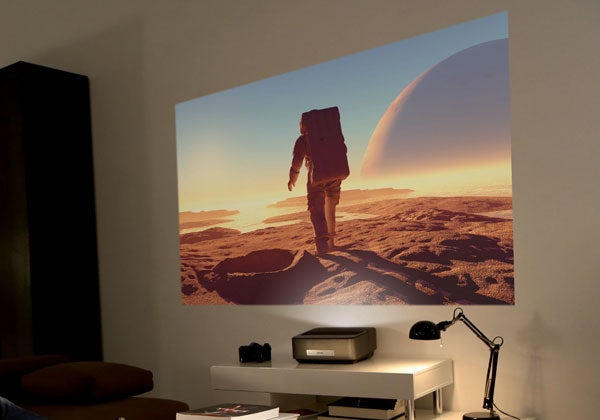 Philips Screeneo HDP1590TV projecting a movie scene on wall.