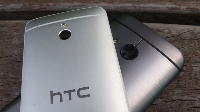 HTC One Mini 2 smartphone next to another device.