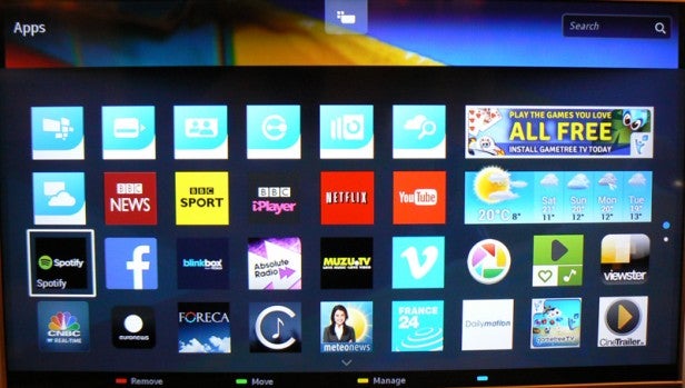 Smart TV interface with various application icons displayed.