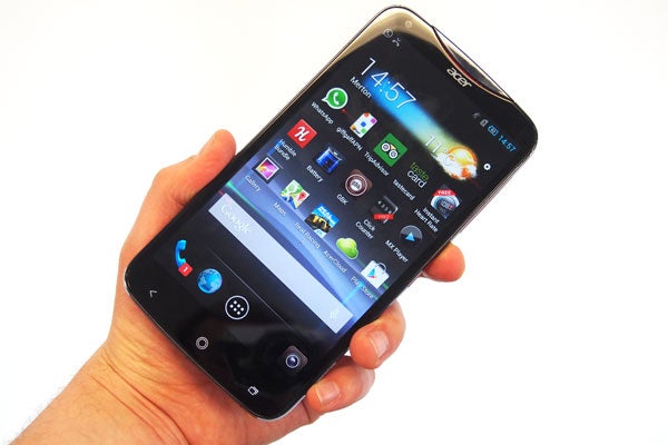 Hand holding Acer Liquid S2 smartphone displaying apps on screen.