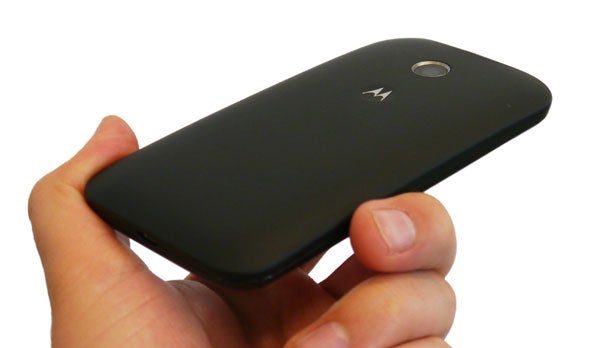 Hand holding a black Motorola Moto E smartphone.