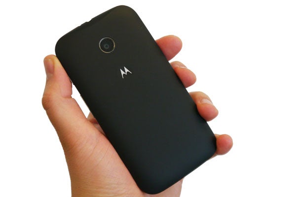 Hand holding a black Motorola Moto E smartphone.