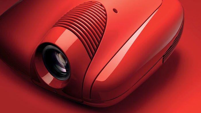 Red Sim2 Fuoriserie projector on a red background.