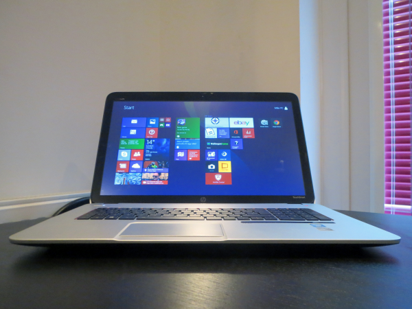 HP Envy 17 Leap Motion SE laptop on a desk displaying Windows Start screen.