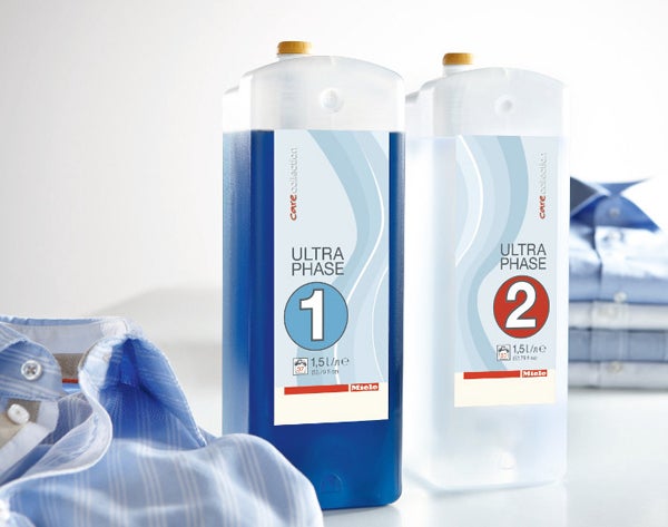 Miele UltraPhase 1 and 2 detergent bottles with shirt