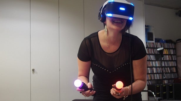 Woman playing with PlayStation VR and motion controllers.Person using PlayStation VR headset and motion controllers.