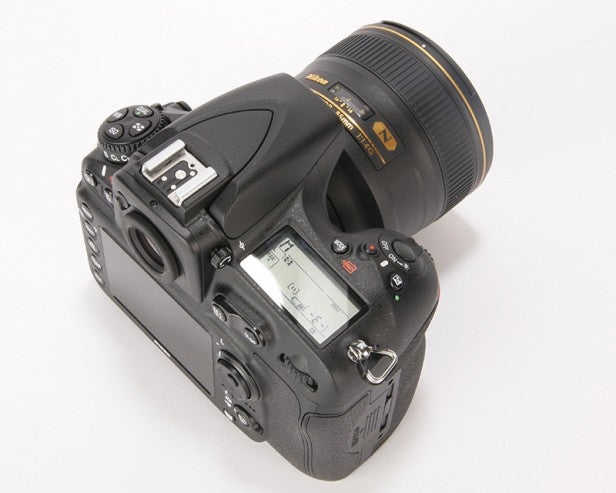 Professional DSLR camera with a telephoto lens.