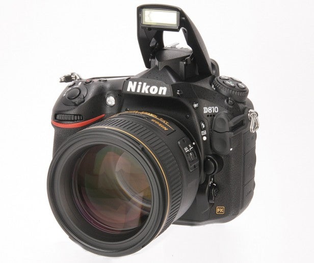 Nikon D810 DSLR camera with lens and raised flash.